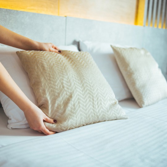 bed in bedroom cleaning at Greenwich ct home